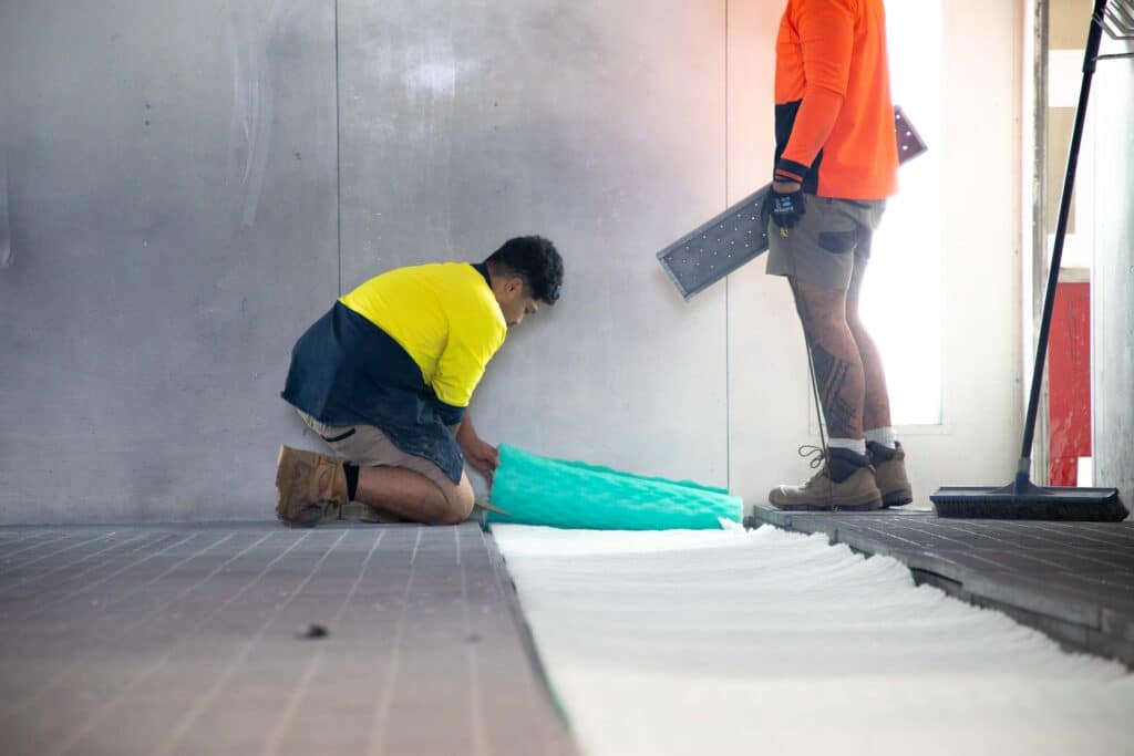 replacing the floor filter in a spray paint booth with the EU3 Fiberglass filter