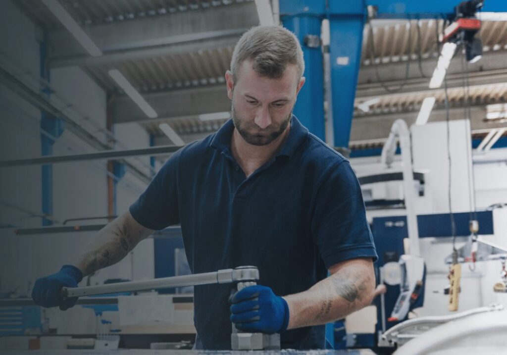 Technician servicing spray booth equipment