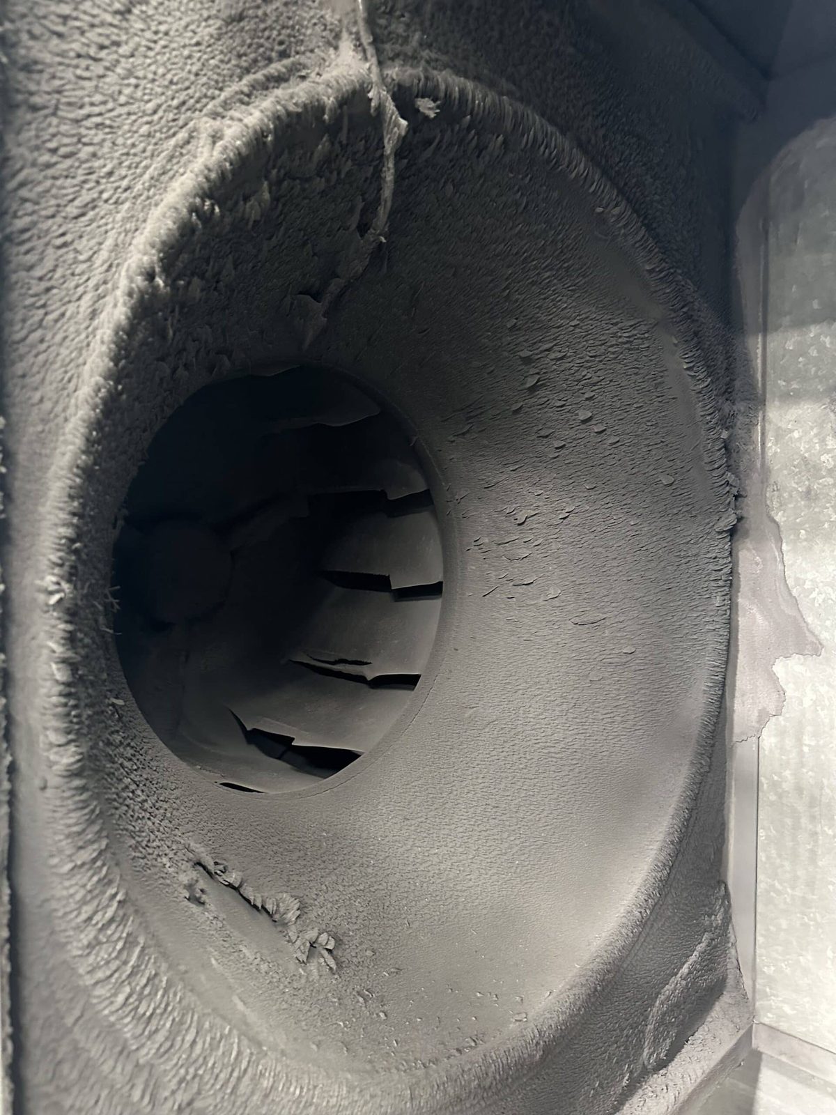 Overspray build up on a spray booth exhaust fan